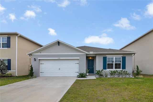 view of front of house featuring a garage and a front lawn