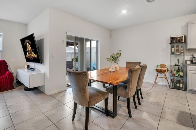 dining room featuring light tile patterned flooring and a wealth of natural light