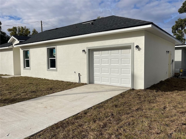 view of property exterior featuring a garage and a lawn