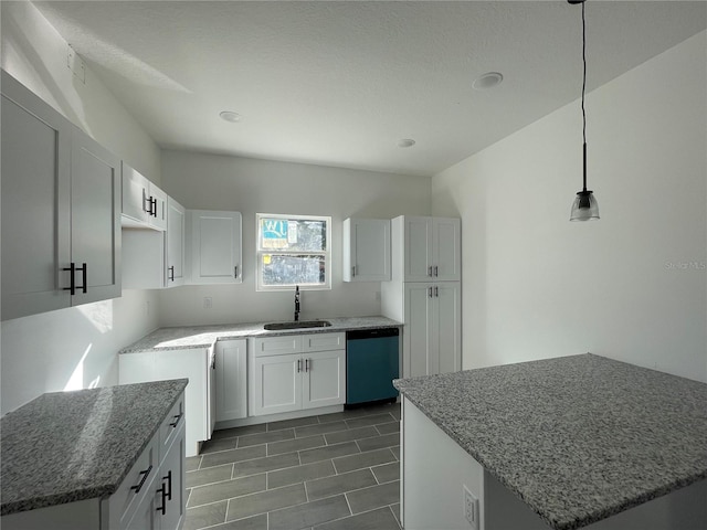 kitchen with sink, dishwasher, a kitchen island, pendant lighting, and white cabinets