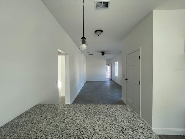 hallway featuring dark tile patterned floors