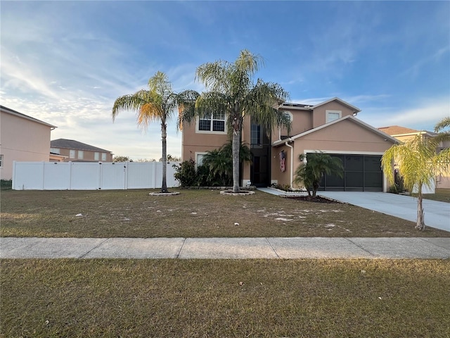 view of front of property featuring a garage and a front yard