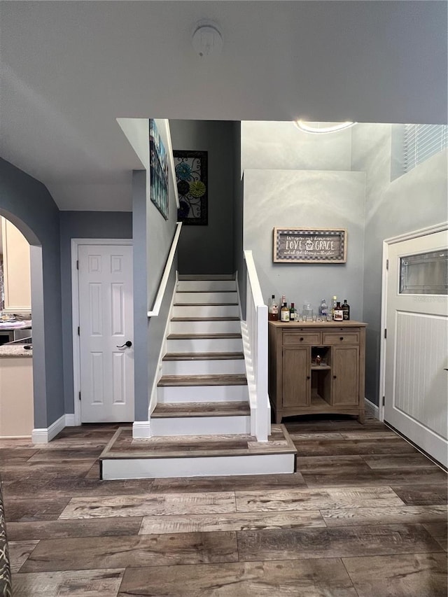 stairs featuring wood-type flooring