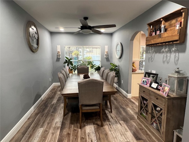 dining space featuring dark wood-type flooring and ceiling fan