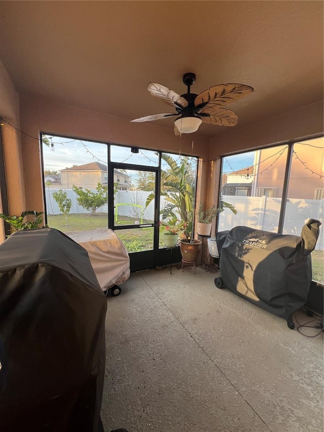 sunroom featuring plenty of natural light and ceiling fan