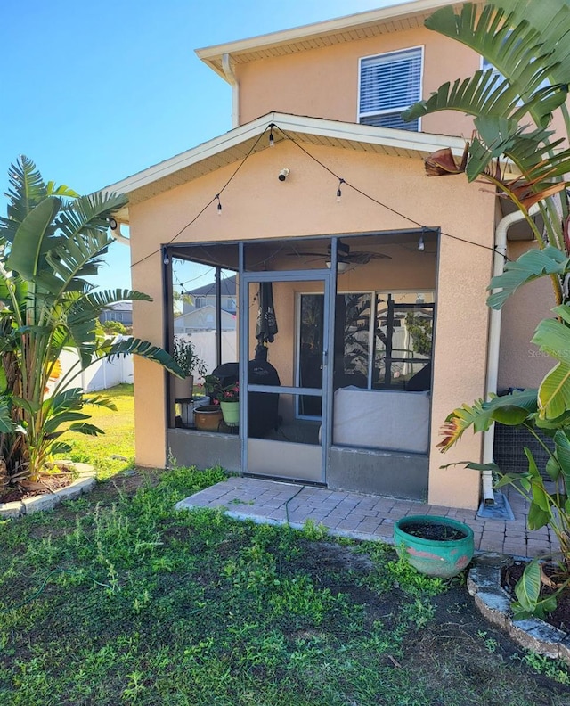 rear view of house featuring a sunroom