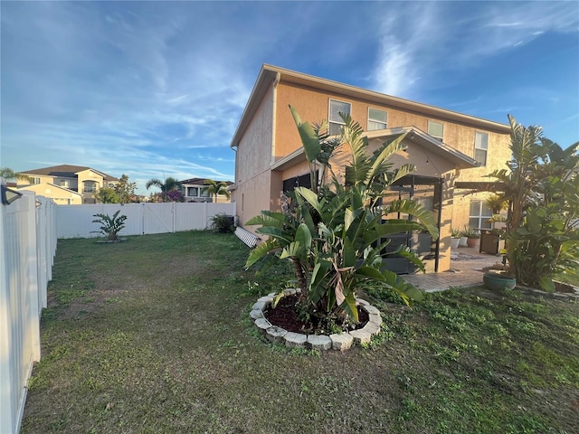 exterior space featuring a lawn and a patio