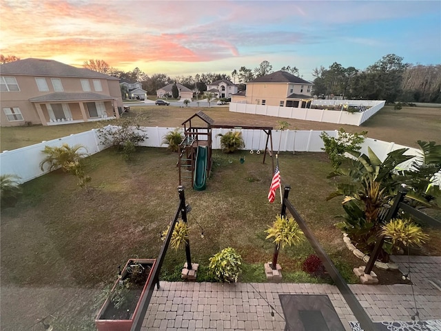 view of property's community with a playground and a lawn