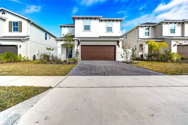 view of front of property featuring a garage and a front lawn