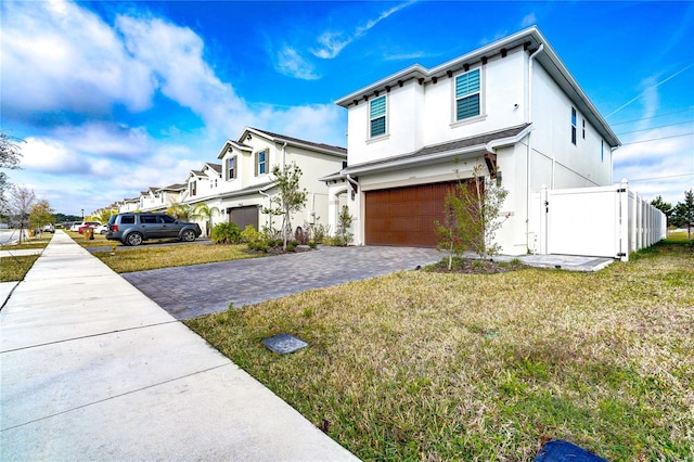 view of front facade featuring a garage and a front lawn