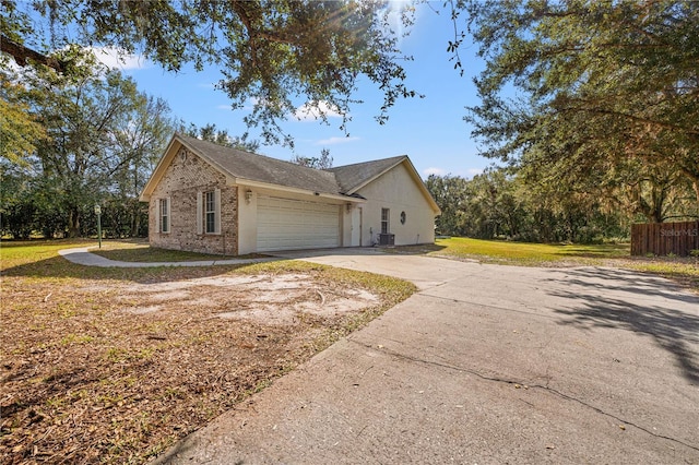 view of home's exterior featuring a garage and a yard