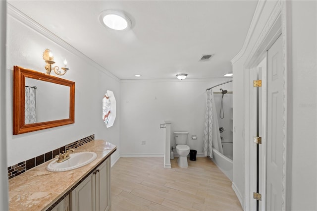 full bathroom with hardwood / wood-style floors, ornamental molding, vanity, shower / tub combo, and toilet