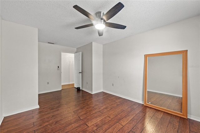 spare room featuring ceiling fan, dark hardwood / wood-style floors, and a textured ceiling