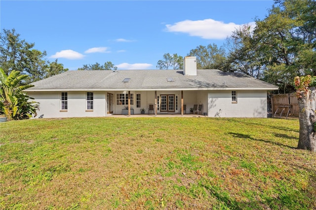 back of house featuring french doors, a yard, and a patio