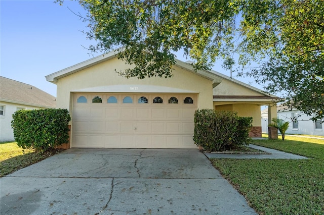 ranch-style house with a garage and a front yard