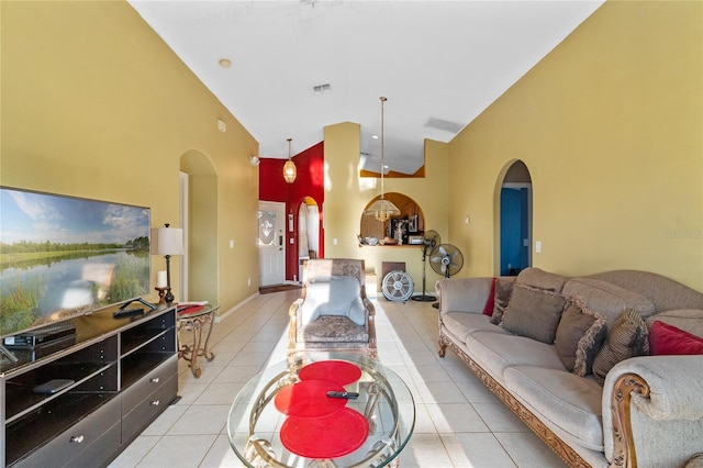 tiled living room featuring high vaulted ceiling