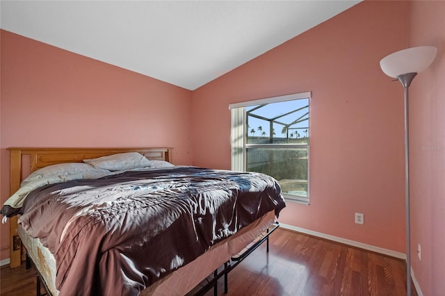 bedroom featuring wood-type flooring and vaulted ceiling