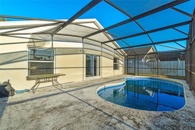 view of swimming pool featuring a lanai and a patio area