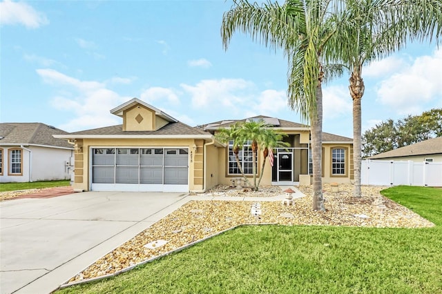 single story home featuring a garage and a front yard