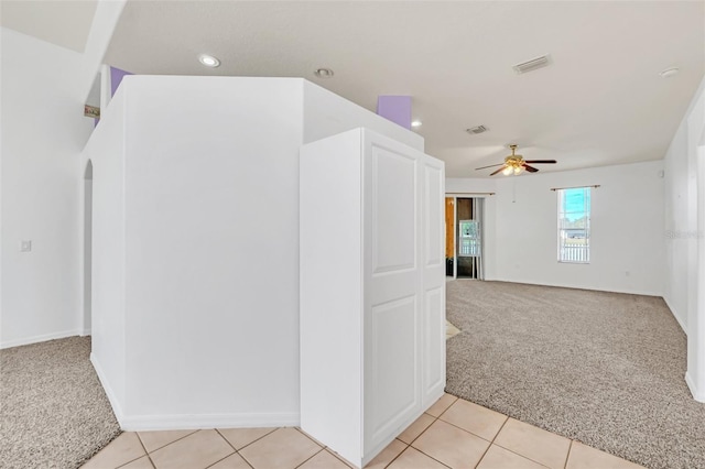 carpeted spare room with ceiling fan