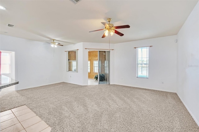 unfurnished living room featuring ceiling fan and light carpet