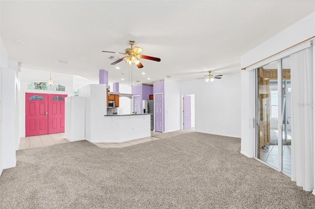 unfurnished living room with plenty of natural light, light carpet, and ceiling fan