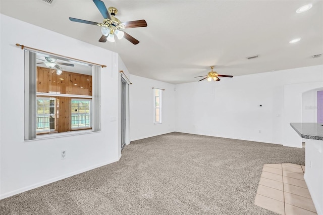 unfurnished living room with carpet flooring and ceiling fan