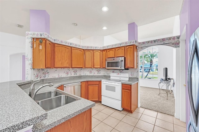 kitchen with light tile patterned flooring, appliances with stainless steel finishes, and sink