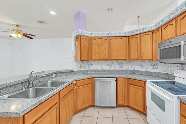 kitchen featuring sink, light tile patterned floors, kitchen peninsula, ceiling fan, and stainless steel appliances