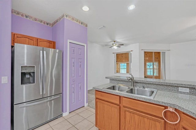 kitchen featuring stainless steel refrigerator with ice dispenser, ceiling fan, sink, and light tile patterned floors