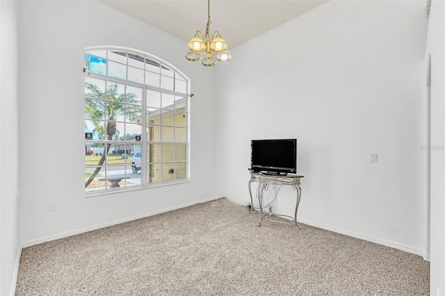 interior space featuring carpet flooring and a chandelier