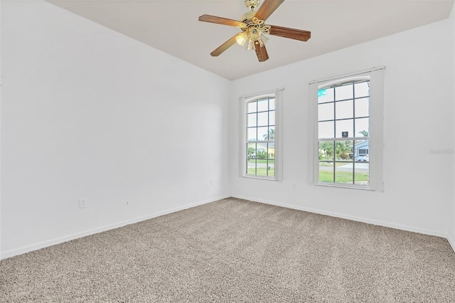 spare room featuring ceiling fan, vaulted ceiling, and carpet