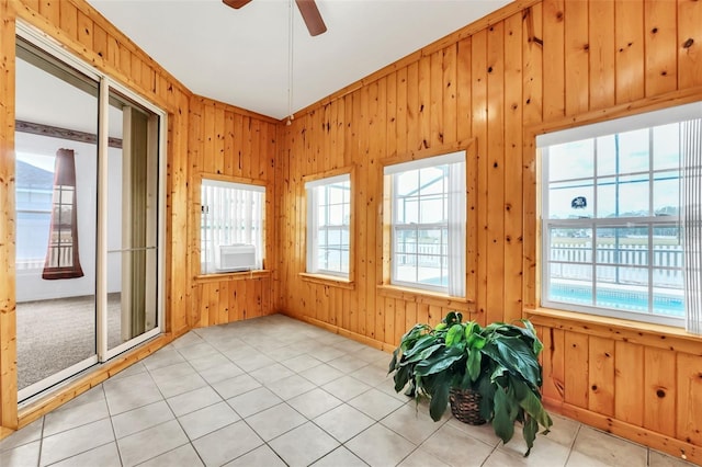 unfurnished sunroom with ceiling fan