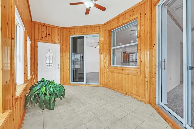 sunroom featuring ceiling fan