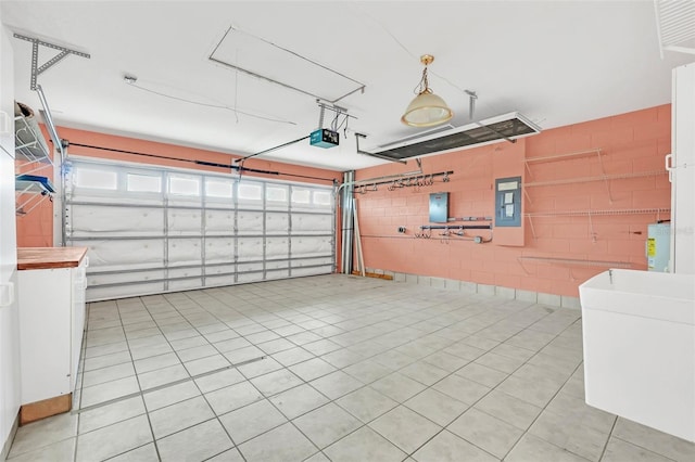 garage featuring a garage door opener and electric panel