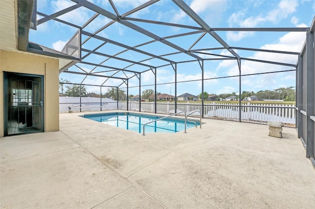 view of swimming pool featuring a patio area and glass enclosure