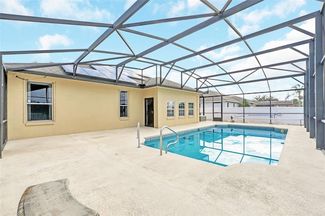 view of swimming pool featuring a patio area and glass enclosure