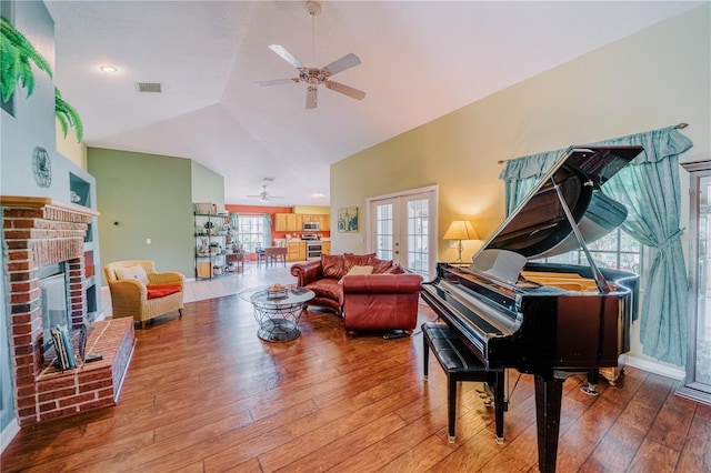 living area with french doors, lofted ceiling, and hardwood / wood-style flooring