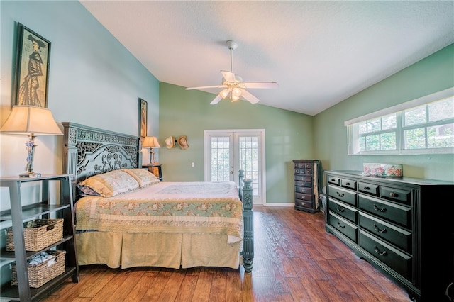 bedroom with multiple windows, lofted ceiling, dark wood-type flooring, and french doors