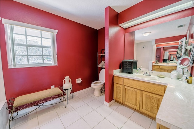 bathroom featuring tile patterned flooring, vanity, and toilet