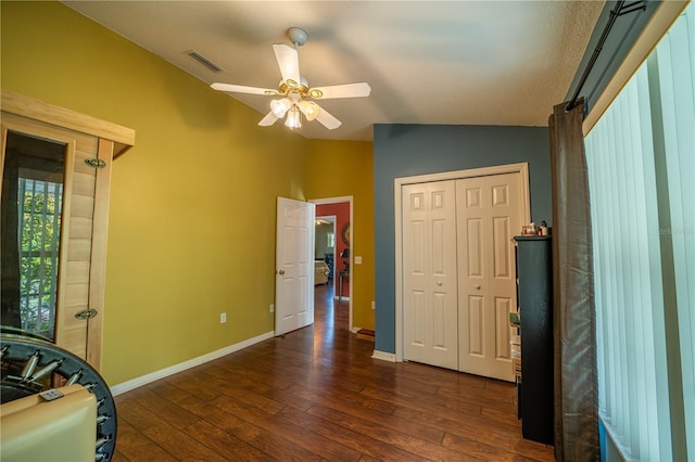 bedroom with ceiling fan, lofted ceiling, dark hardwood / wood-style flooring, and a closet