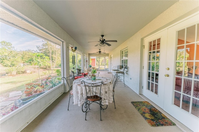 sunroom / solarium with ceiling fan and french doors