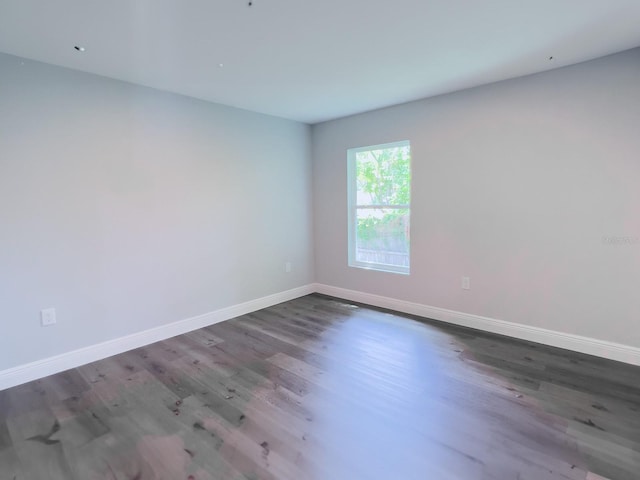 spare room with dark hardwood / wood-style flooring