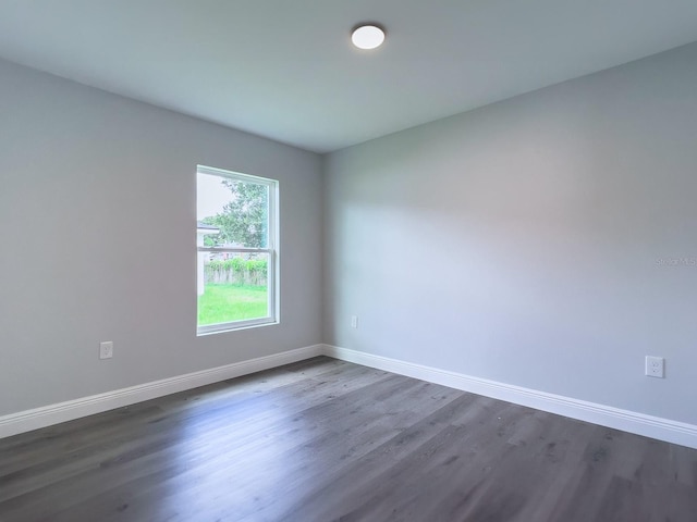 empty room featuring dark wood-type flooring