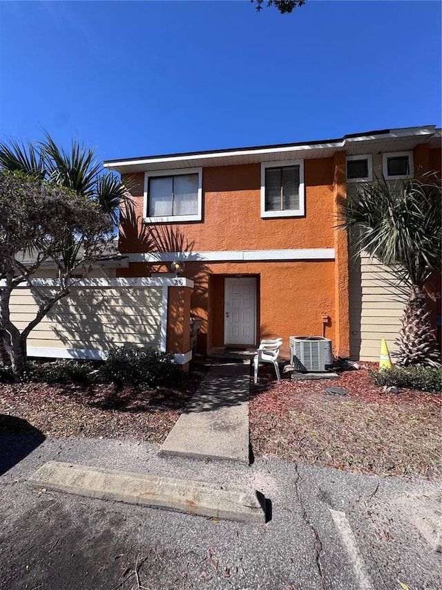 view of front of house with a garage and central AC unit