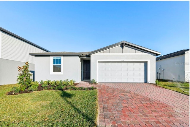 ranch-style house featuring a garage and a front yard