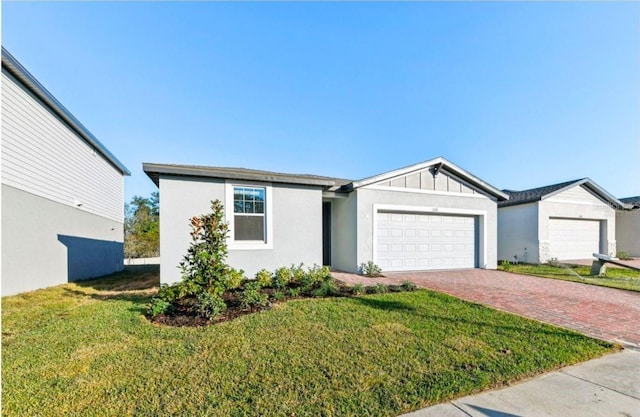 ranch-style house featuring a garage and a front lawn