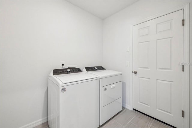 clothes washing area with washing machine and clothes dryer