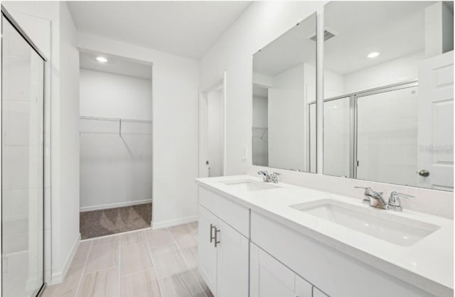 bathroom featuring vanity and a shower with door