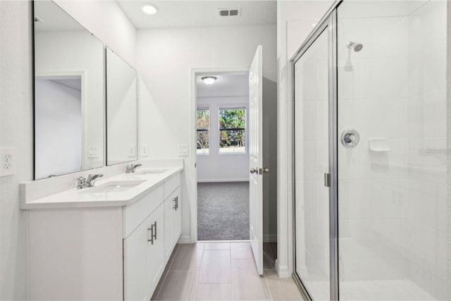 bathroom featuring an enclosed shower and vanity